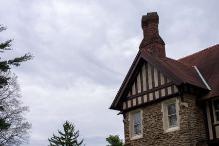 A Detailed and Ornamental Cobblestone Building With a Red Roofの写真素材
