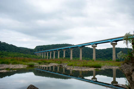 The Norman Wood Bridge OVer the Susquehanna River Reflecting Itself in a Small Body of Water on a Cloudy Dayの写真素材