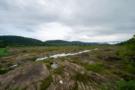 A Huge Sprawling Landscape Covered in Rock Formations and Plants With the Norman Wood Bridge in the Backgroundの写真素材
