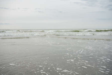 A View of the Horizon Over the Ocean at the Beach on an Overcast Skyの写真素材