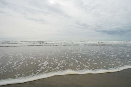 A View of the Horizon Over the Ocean on the Beach on a Cloudy Grey Skyの写真素材