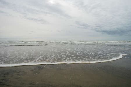 A View of the Horizon Over the Ocean on the Beach on a Cloudy Grey Skyの写真素材