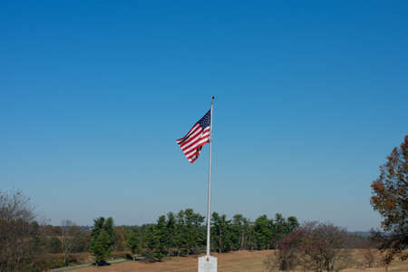 The American Flag Flying on a Clear Blue Sky at Valley Forge National Historical Parkの写真素材