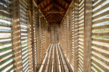 An Old Thin Wooden Shack With Unique Lines of Light and Shadows Cast From the Sun