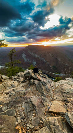 A Young Caucasian Man Wearing All Black Standing at the Top of Mount Tammanyの写真素材