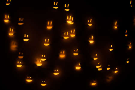 Yellow Smiley Face Shaped Bokeh on a Black Backgroundの写真素材