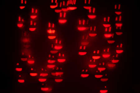 Orange Smiley Face Shaped Bokeh on a Black Backgroundの写真素材