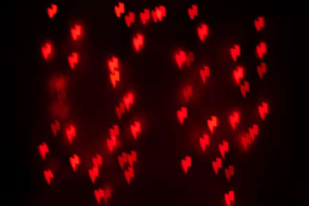 Orange Lightning Bolt Shaped Bokeh on a Black Backgroundの写真素材