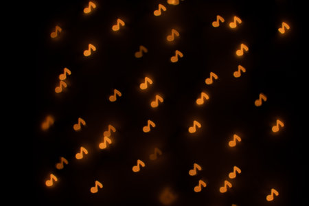 Yellow Music Note Shaped Bokeh on Blackの写真素材