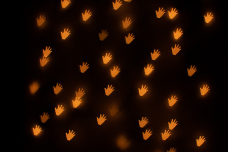Yellow Hand Shaped Bokeh on Blackの写真素材