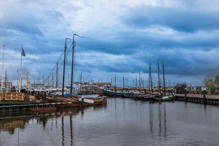 Boat in harbor in Urk city in Holland. Docks where ships are repaired. The background is a blue sky with clouds.の写真素材