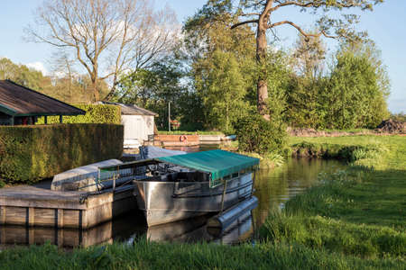 Anchored bed on canal at Glimmen, Holland.の写真素材