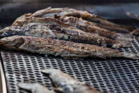 Whole and portioned fresh grilled fish for sale on the market.の写真素材