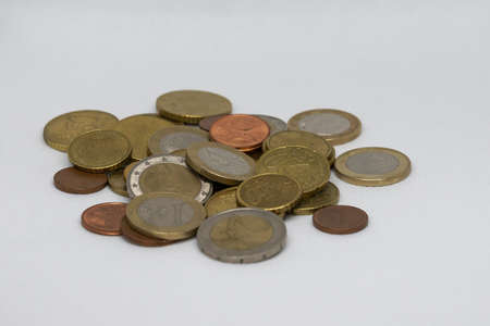Various metal EURO coins on a stack on a white background