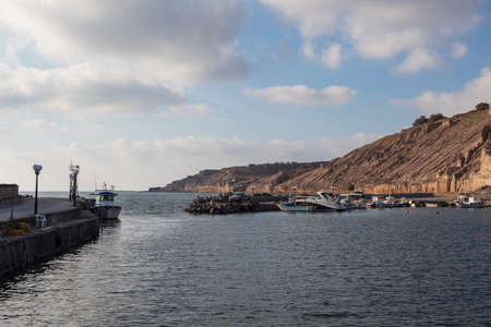 Port for Kanakari fishing boats on Santorini island in Greece. Blue sky and sunny weather.の写真素材