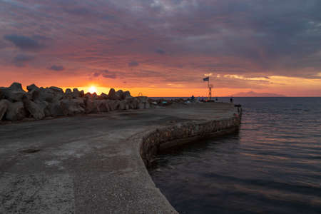 Sunrise at the beach In Monolithos at the lighthouse on Santorini island in Greece.の写真素材
