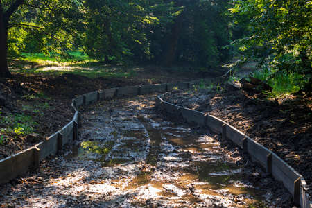 Dredged water canal in the park in the castle garden in Kromeriz in the Czech Republic.の写真素材