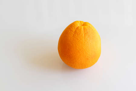 Whole orange isolated on white background makes a shadow.の写真素材
