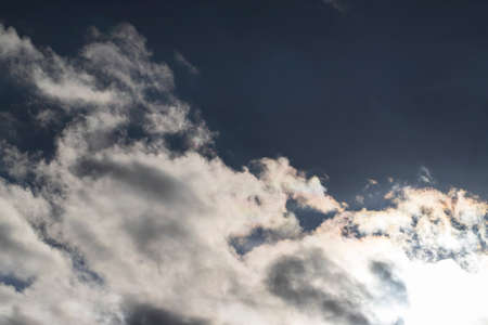 White dramatic clouds in the blue sky.