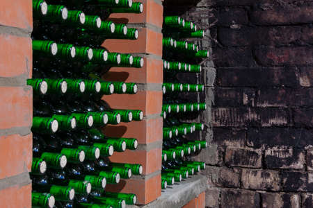 Wine glasses are stacked on the shelf in the wine cellar.の写真素材