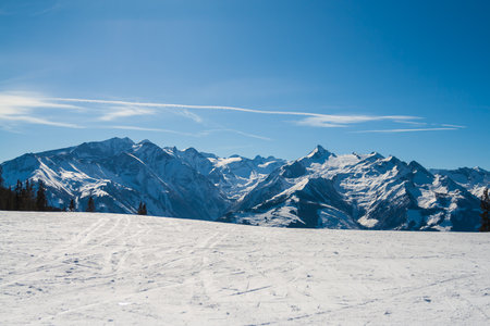 View of the snow-capped mountains in the Schmitten ski area in Zell am See. In the background is a beautiful sky with clouds.の写真素材