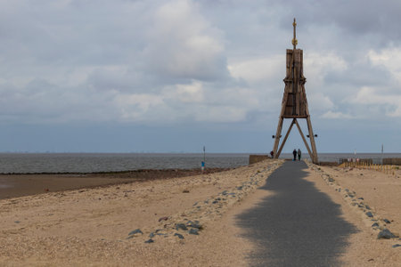 Beautiful North Sea coast of Cuxhaven in Germany. Overcast sky with clouds over the sea at low tide.のeditorial素材