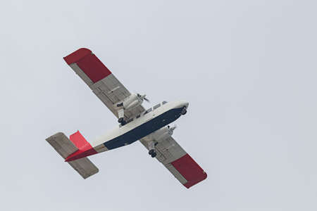 A small plane takes off and takes off on the island of Dune. Background is bright sky