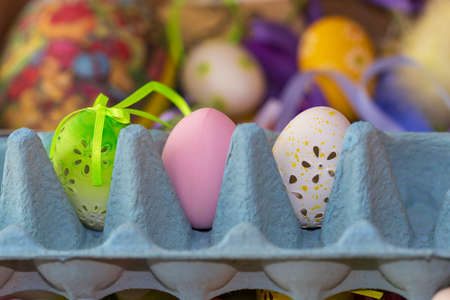Easter egg as decoration. The Easter egg is in the egg carton. The background is monochrome.の写真素材