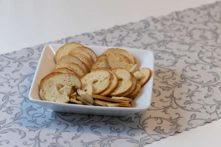 White bowl with garlic flavored Bake Rolls. The bowl is laid on the table.