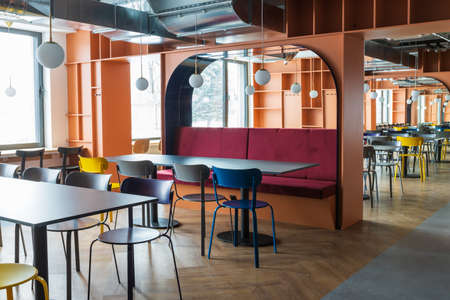 Large public dining room with colorful furniture. The premises are without people.