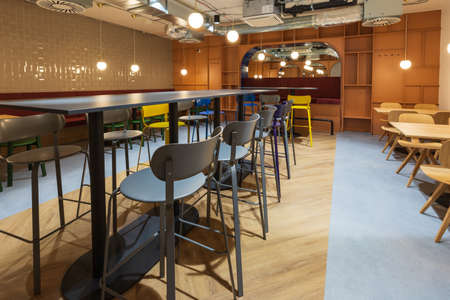 Large public dining room with colorful furniture. The premises are without people.
