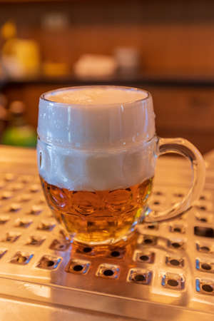 Draft beer in pulliter - shnyt. Small beer in a big glass.の写真素材