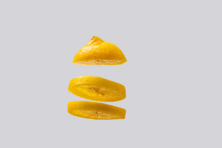 Yellow lemon slices in a row on top of each other. Lemon is isolated on a white background.の写真素材