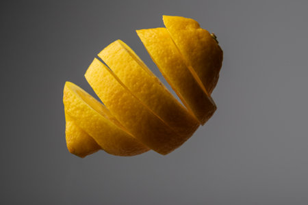 Sliced yellow lemon in space on a dark background.の写真素材