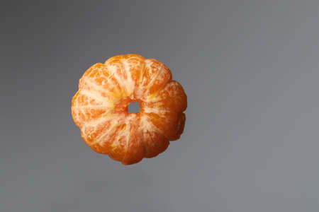 Tangerine wheels on a dark background. The background is black and white.の写真素材