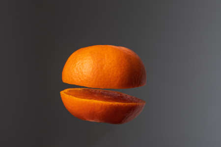 Tangerine wheels on a dark background. The background is black and white.の写真素材