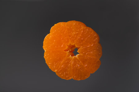 Tangerine wheels on a dark background. The background is black and white.の写真素材