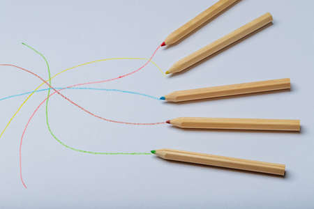Wooden colored crayons on a white background.
