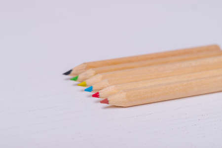 Wooden colored crayons on a white background.の写真素材