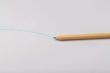 Wooden colored crayons on a white background.