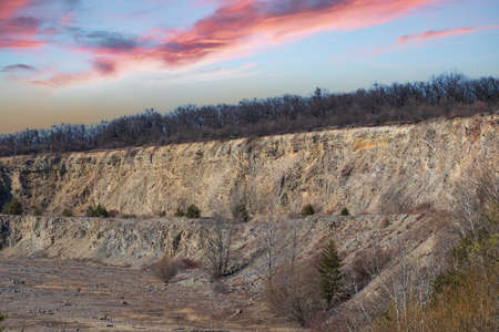 Terraces in an enclosed quarry. The background is a beautiful sky.