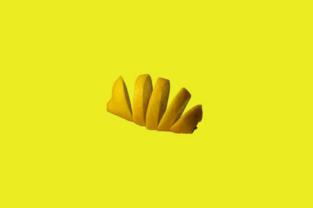 Lemon wheels in the middle of the air on a yellow background.の写真素材