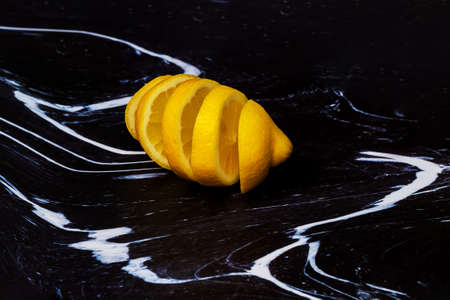 Sliced lemon lies on a dark background.の写真素材