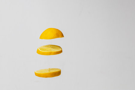 Lemon wheels on top of each other on a white background.