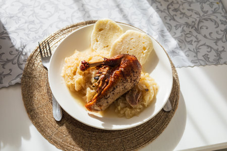 Excellent food. Golden roasted duck with cabbage and dumpling on a plate.の写真素材