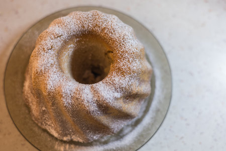 Homemade cake on a plate. There is white sugar on the cake. Baked cakeの写真素材