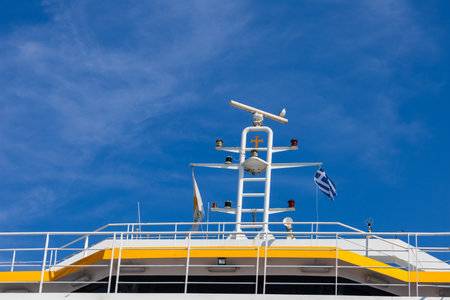 A seagull sits on top of a large Greek ship.