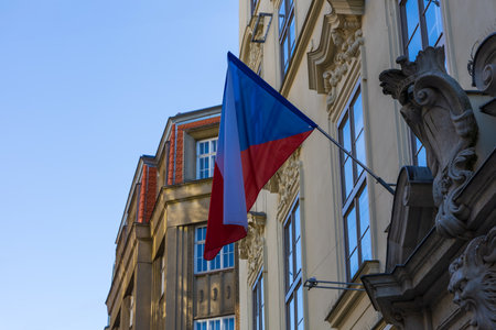 The national flag of the Czech Republic hangs on a houseの写真素材