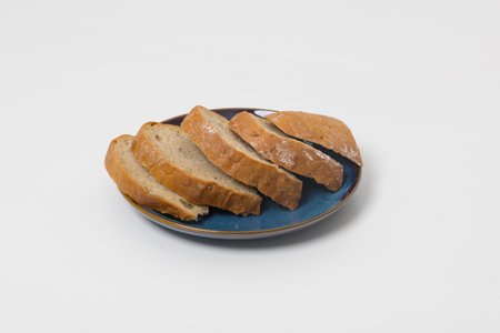Sliced ââbread on a plate. The background is whiteの写真素材