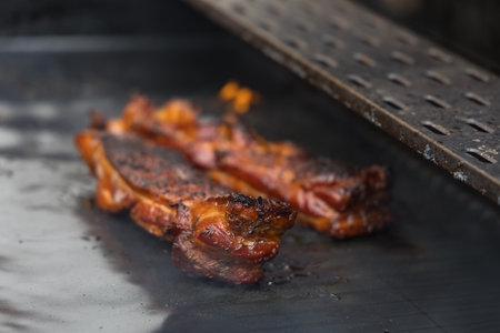 Smoked pork belly grilled on an open grillの写真素材